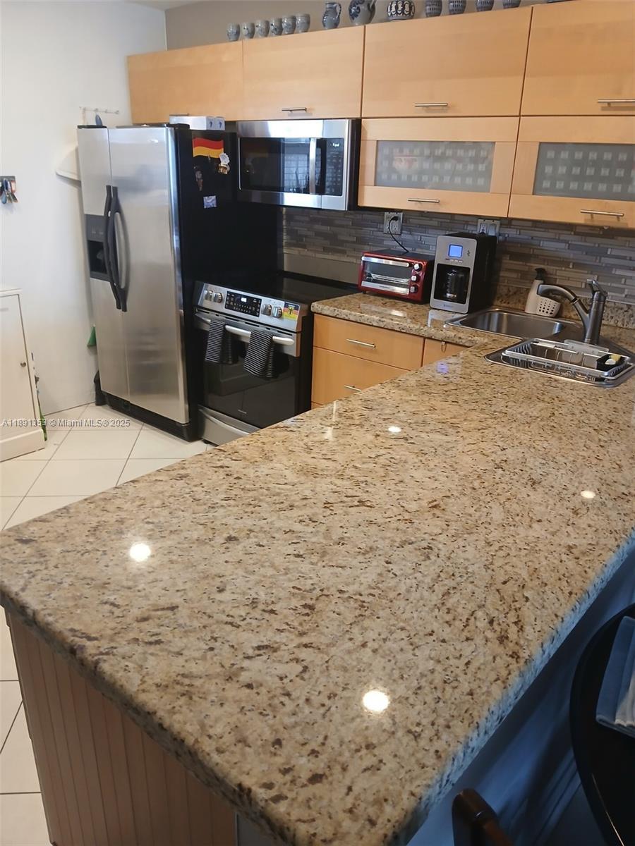 Totally renovated kitchen w/ new cabinets granite countertops w/ beautiful tile backsplash stainless steel appliances dishwasher stove w/ microwave and refrigerator LED lighting throughout large living room and bedroom upgraded bath w/ large walk in all tile shower new vanity and sink w/quartz top balcony w/ pool view impact windows throughout tankless water heather electronic entry 40 and 50 year certification Completed cable & water included in maintenance bike room + extra storage space 1 mile to beach close to shopping and transportation a must see