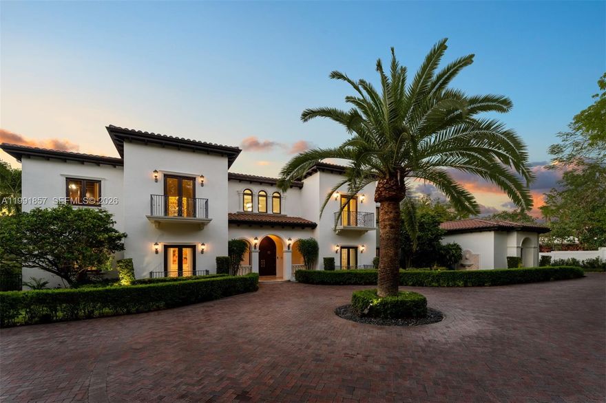 Timeless Mediterranean estate set on nearly an acre, offering 9 bedrooms, 8 full baths and 1 half bath across a well-designed layout. A welcoming foyer introduces formal and casual living spaces, highlighted by a spiral staircase leading to second-floor balconies and a seamless indoor-outdoor flow. The home includes a wine cellar,and covered terraces suited for entertaining. The primary suite features dual walk-in closets and a private setting. Outdoors, a pool with tanning ledge, jacuzzi, and fully equipped summer kitchen create a comfortable retreat. A fireplace, separate guest house, and 4-car garage complete this well-appointed residence.