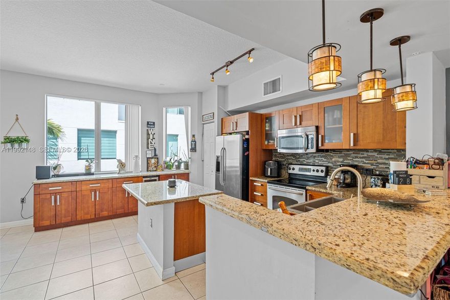 For Sale in Courtyards at Hollywood Station across the boulevard
Townhouse #306 is perfectly positioned directly across from the community pool. This light-filled, modern 3-story townhome is one of the best-located residences in vibrant Downtown Hollywood. The flexible first-floor den can be enclosed to create a true 4th bedroom, or used as a home office, gym, media room, or guest space. Enjoy 10-foot ceilings and a main level designed for entertaining, with an open living/dining layout, a formal dining area, and a kitchen featuring an island plus generous cabinet storage. Two balconies capture relaxing garden and pool views and bring in abundant natural light. Upstairs, the primary suite offers two closets (including one walk-in) and a spacious bath with whirlpool tub, dual vanities, and a separate shower. Additional highlights include a brand-new A/C system, impact-resistant windows, in-unit washer and dryer, and a private attached 2-car garage. Low monthly maintenance fee of $497. Residents park in their garage, and the community provides guest passes for a private parking area. Rental policy allows rentals up to 4 times per year; short-term rentals are not permitted, helping protect the community environment. A pre-inspection has been completed and is available upon request. Walk to Downtown Hollywood's top-rated schools, dining, shopping, parks, and entertainment for all ages; ride a bike to the beaches, and FLL airport and the Hard Rock Hotel & Casino are minutes away.