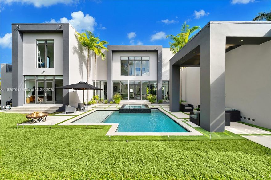 Welcome to Casa Oasis! This modern waterfront masterpiece offers spectacular golf course views and 146 feet of canal frontage with direct access to Biscayne Bay. Nestles in a cul-de-sac, 4,796 SQFT main house offers an open-concept design with formal living and dining, gourmet kitchen, family room, hobby room, and media center on the first floor. Upstairs, the master suite features a walk-in closet, private lounge, and en-suite bathroom, while two bedrooms shares a Jack-and-Jill bathroom. The detached guest house includes an additional bedroom, bathroom, and living space with water views. Outdoors, enjoy the pool, infinity Jacuzzi, waterfront dock with heavy duty boat lift, and floating dock. Next to Miami Shores Country Club with an 18-hole golf course, tennis, and top private schools