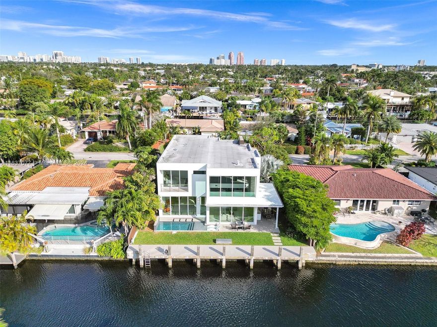 The Best Deal For A Waterfront Home! Presenting A Luxurious Contemporary Home Built In 2018. Tastefully Decorated By Interior Designer. 4 Smart TVs. This Custom House Has High-Quality Finishes, 25 Ft. Ceilings, Featuring An Abundance Of Windows & Doors That Bring The Outdoors In, 2-Story Modern Home With Natural Light & Showcasing The Tropical Setting. Kitchen Has Top-Of-The-Line Appliances, Lots Of Storage, Making It A Chef's Dream. An Outdoor Patio & Summer Kitchen. Anti-Mosquito System, Custom LED Lights. The Primary Bedroom On The First Floor Has Gorgeous Views Of The Pool & Water. 70 Feet Of Water Frontage & Access To The Ocean. This House Is Located On A Quiet Street, Offering Privacy and Tranquility. Just Minutes Away From Trader Joe's, Whole Foods & Newly Opened Pura Vida!