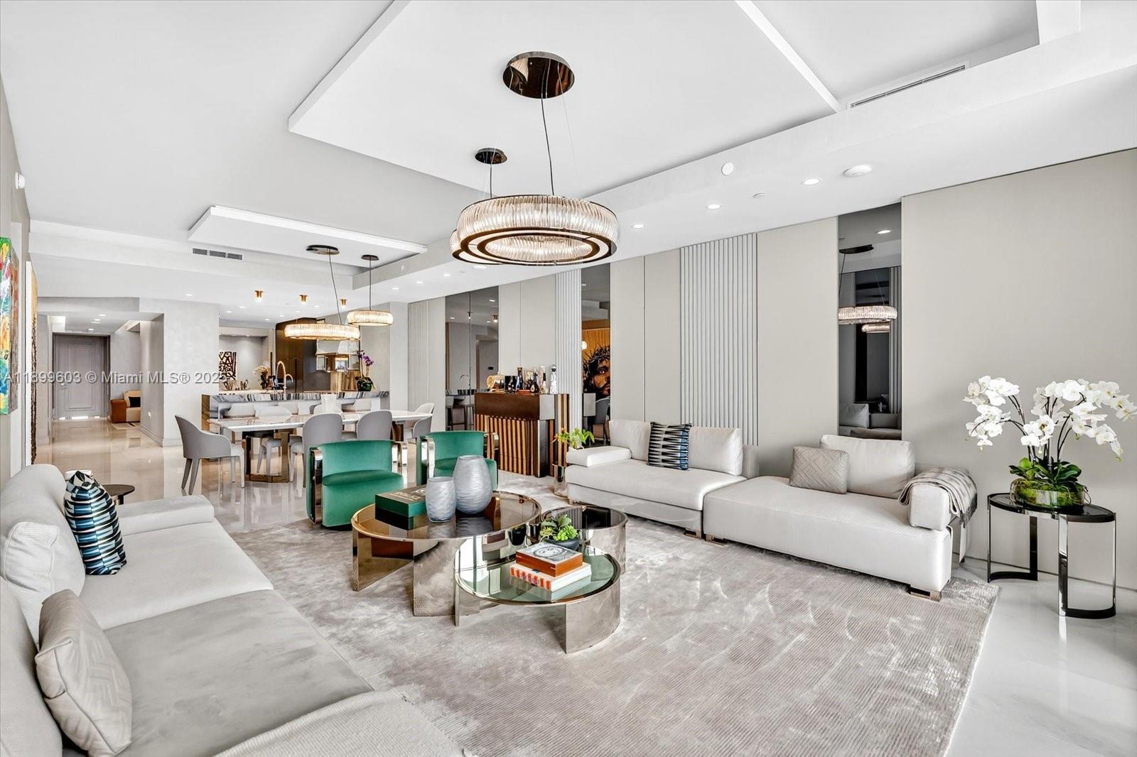 Welcome to The Estates at Acqualina—where luxury meets the ocean. This exceptional turnkey residence, designed by Estudio Jorge Fuentes, is fully furnished and finished to perfection with Fendi Casa and Trussardi Casa décor, Armazem Design millwork, and smart home technology throughout. The primary suite features onyx in bathroom, steam shower, freestanding tub, and his & hers dressing rooms. A flow-through layout offers 4 bedrooms, 5 baths, den, media room, service quarters, marble floors, and a private foyer. The open chef’s kitchen with imported stone countertops and top appliances overlooks floor-to-ceiling windows framing breathtaking panoramic ocean views.