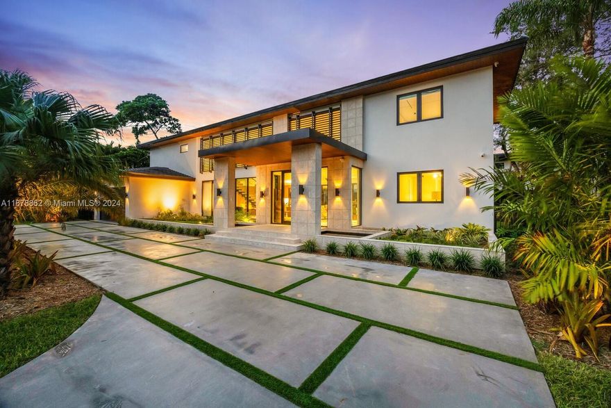 This new construction modern tropical home in South Miami offers 5 bedrooms & 5.5 bathrooms, blending natural materials with a sleek contemporary design. It features water elements, wooden accents, rock elements, large windows, & a circular driveway finished in concrete with artificial turf. The first level showcases 24x48 Sandstone Silk White porcelain flooring, while the second level boasts all wood flooring. The MiaCucina kitchen is outfitted with quartz Calacatta Ocean Gold countertops & Thermador appliances. The home includes 2 ensuite bedrooms downstairs & 3 upstairs, including the primary suite with a beverage center & MiaCucina closets. Outside, you'll enjoy a pool along with a cabana bath & summer kitchen.Other features: Control 4 smart system, electric curtains, & a 2-car garage.