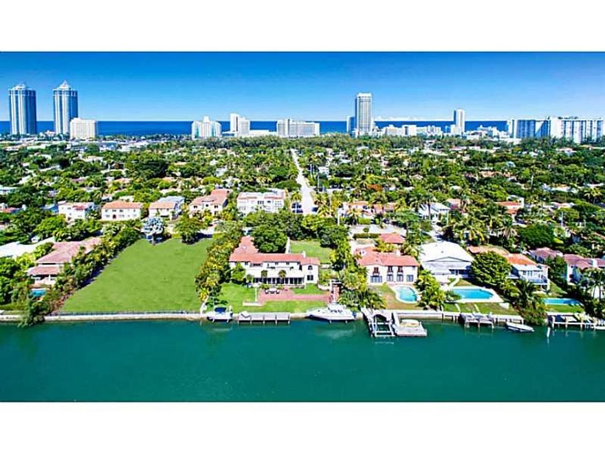 Rare development opportunity to own a one of a kind 24,064SF double lot w/ 128' on the water. Keep the existing +/- 5,000SF structure & finish additions/renovations OR design your own new 12,000SF residence.  Possibility for land to be split into two 12,032 sqft lots allowing for development of 2 residences up to 6,000SF each. Massive yard w/ mature tropical landscaping. Large boat dock w/ 16k lift. Located in a great neighborhood that is walkable to schools, restaurants & houses of worship.