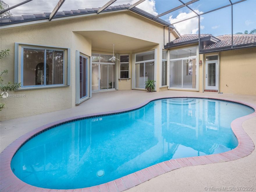 Brand new 2020 Renovations!!!  32x32 Ceramic tile floors JUST INSTALLED.  Popcorn ceilings removed. Custom one story tucked in the gated community of Weston Hills Country Club. Spacious floor plan with five bedrooms and three full baths. Enjoy a quiet evening poolside in your screened patio with a new pump, lushly landscaped for privacy. Soaring ceilings welcome you with windows on the sparkling pool.2019 Renovated kitchen with white Maple wood cabinetry, Stainless Steel appliances, and New granite countertops. 2020 Master bathroom updated.  2019 Updated wood laminate flooring in all bedrooms. New water heater 2018. Full accordion protection. New Roof installed in 2013 and new hurricane garage door 2017.