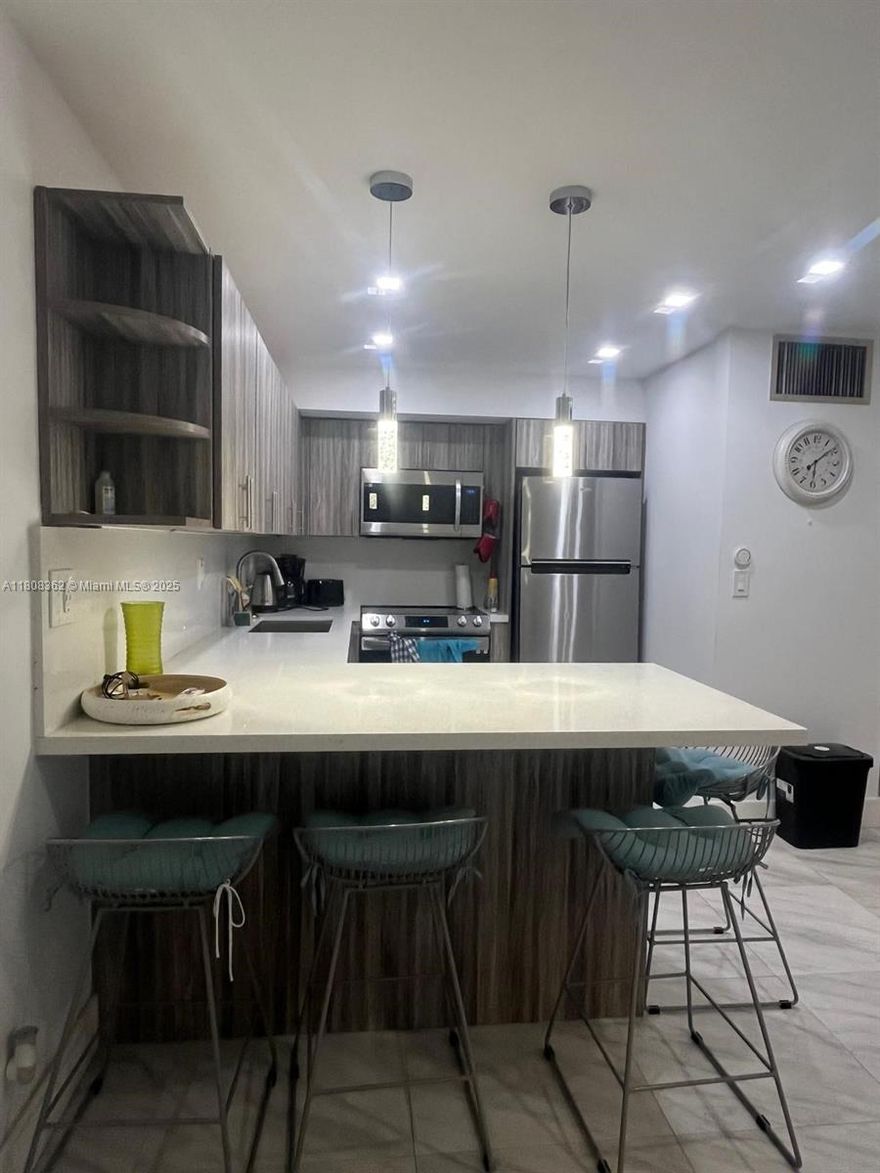 Great Unit Views! RENOVATED 2-bedroom, 1-bathroom. Featuring a brand new beautiful kitchen & new gorgeous flooring throughout! A prime location, within walking distance of the rapidly growing downtown Hollywood, & just minutes away from the beach. Walking distance to restaurants, dance clubs, & art galleries. Close to a major airport & the world famous Hard Rock Casino. The clubhouse features a large pool, laundry, & newer elevators and Guest parking. A very LOW maintenance fee. COMPLETELY UPDATED BRAND NEW ROOF.