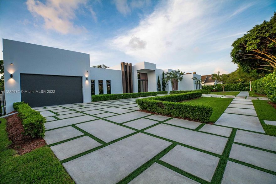 Pinecrest Gem waiting to be discovered.  Extraordinary inspired New Modern masterpiece built with elegant finest finishes on almost an acre+ indoor/outdoor living.  Dramatic volume ceilings, doors and floor to ceiling impact glass that provides ample natural light to the interior.  This sensational home offers ultra-modern and sophisticated kitchen with Italian Kitchen cabinets, Quartz counters, Wolf and SubZero Appliances.  Also, wine cellar, smart security system/cameras, office, full house generator, fabulous outdoor kitchen, and family room area, outdoor jacuzzi and lounging area with 70ft heated infinity pool.  Gem offers 6 master suites bedrooms with finished closets. A truly unparalleled design.