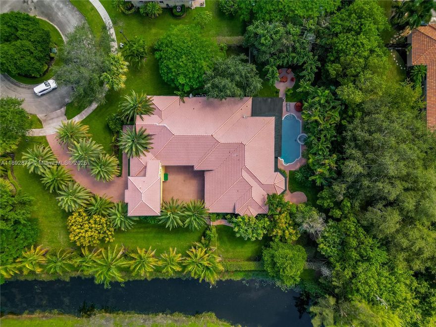 Experience peace and sophistication in the exclusive gated community of Saddlebrook in Davie. This stunning residence features 6 bedrooms and 5 bathrooms. The spacious master suite includes custom walk-in closets and a versatile sitting area perfect for a home office or gym. Elegant marble and hardwood flooring complement the custom window treatments throughout. The open-concept kitchen boasts stainless steel appliances and connects seamlessly to the formal dining and living areas 
Enjoy the outdoor patio with a built-in BBQ area, pool, and jacuzzi—perfect for relaxing in your own retreat. Located on a quiet cul-de-sac, this property offers both safety and serenity. Conveniently close to Vista View Park and top-rated public and private schools.Complete hurricane protection included