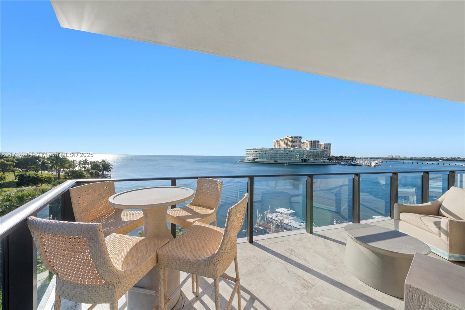 RARE BOHO-CHIC DESIGNER RESIDENCE WITH STUNNING DIRECT BAY VIEWS TUCKED AWAY AT THE FAIRCHILD COCONUT GROVE! Open Bay & Sunrise Views from this Waterfront Home designed by Blue Sky Environments in a Bohemian-Contemporary Style. 3,183 SF Interior + 782 SF Terrace. 4 Beds + 4.5 Baths. 11FT Ceilings & Flooded w/Natural Light thru Floor-to-Ceiling Windows. Open floorplan in Pastel Blue & Beige + Custom Wet Bar. Kitchen w/Massive Quartz Eat-in Island, Poliform Cabinetry, Sub-Zero Appliances + Wolf Gas Range. Primary Suite w/Lounge area + Bath w/Duravit Tub. Custom Wallpapers, Drop-Lighting, Oak Floors, Dornbracht & Duravit Fixtures. Storage + 2 Parking Spaces + Electric Car Charger. Boutique Building by Architect Max Strang. 24HR Valet, Gym, Rooftop pool & outdoor cinema.