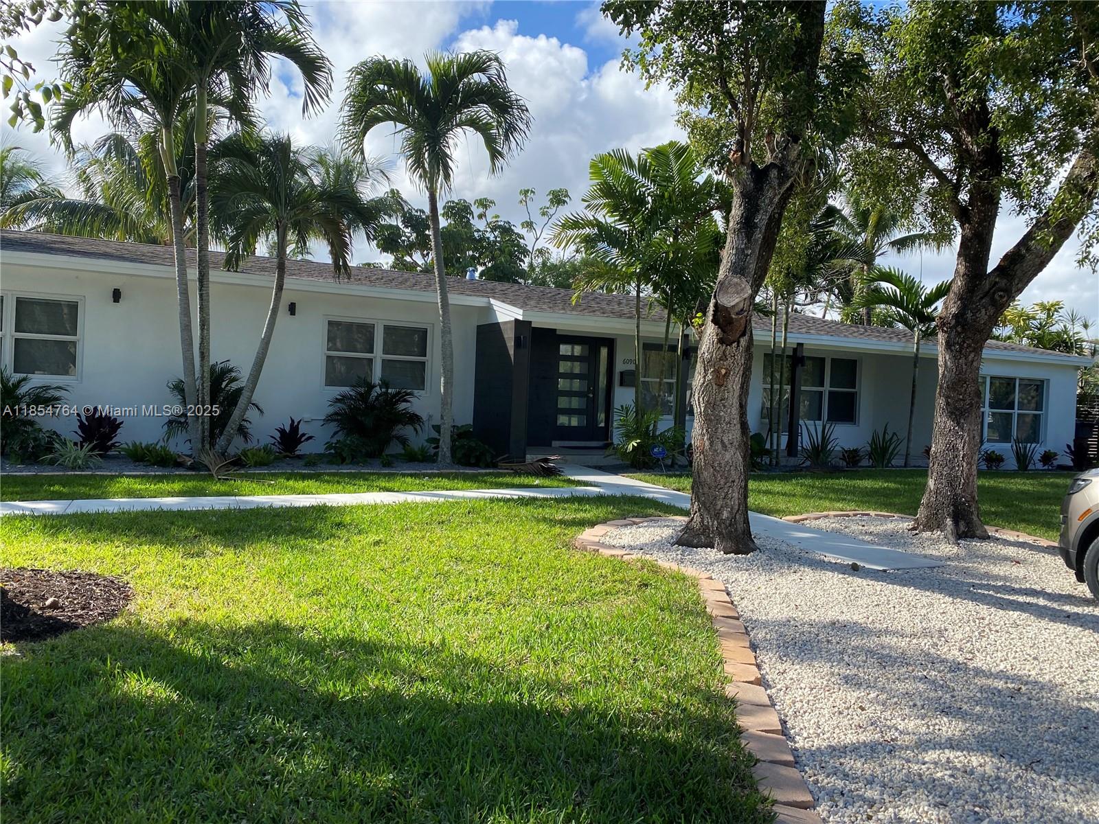 Welcome to this charming single-family home nestled on a quiet street in the heart of South Miami. Perfectly located just minutes from South Miami Hospital, the Shops at Sunset Place, the University of Miami and major highways, this home offers the ideal blend of suburban tranquility and urban convenience. Featuring 4 spacious bedrooms-including 2 primary suites-and 3 full bathrooms, this property is designed for comfortable and flexible living. The open and bright living and dining area flows seamlessly into a huge family room, perfect for gathering with family and friends. Step outside to a beautiful landscaped backyard overlooking a peaceful canal, where you can kayak, barbeque or simply relax and enjoy the serene water views.