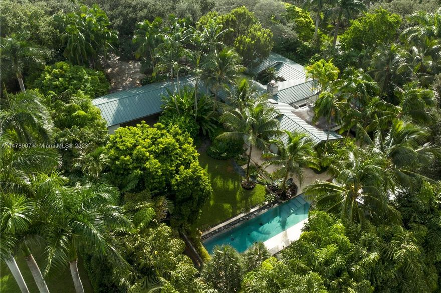 A one-of-a-kind retreat in the heart of Ponce-Davis. Renowned landscape architect Raymond Jungles created meditative and idyllic outdoor spaces with lush foliage and rich textures. The near-acre property includes a heated, infinity edge pool, decorative fountain, native foliage, a generous loggia, and expansive tree canopy. The grounds can be enjoyed from inside the home thanks to large impact windows and doors throughout. The main house features hardwood floors, dramatic wood ceilings, an open and modern kitchen with high end appliances, an office, and bonus room adjacent to the primary suite. The guest house with ensuite bath offers both privacy and comfort. Metal roof, gated entrance, and generator with underground tank. Come be inspired by this magnificent and perfectly located home!