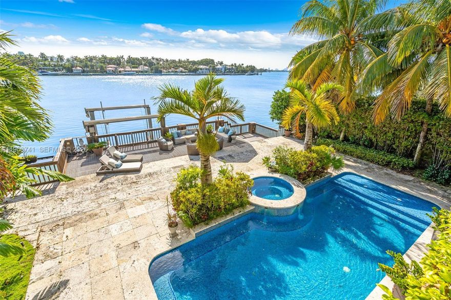 Welcome to this spectacular 5 bedroom, 5 1/2 bathroom private tropical oasis on over 65 feet of open Bay with a 45 foot dock. Live your best indoor/outdoor luxury lifestyle with French doors opening up to beautiful terraces throughout this renovated Mediterranean estate. This incredible home is perfect for entertaining with a gorgeous family room and wet bar overlooking the Bay as well as an incredible eat in chef's kitchen with 60" Wolf Duel Stove with French Top, 45" Subzero refrigerator/freezer, 36" Hoshizaki ice maker, Subzero wine refrigerator, Wolf warming drawer and stunning marble island. The Elan Smart Home is surrounded by 8 foot privacy wall, Hikvision cameras as well as mature lush foliage that creates a secluded dream home. Come see this one of a kind waterfront property. You do not want to miss it!