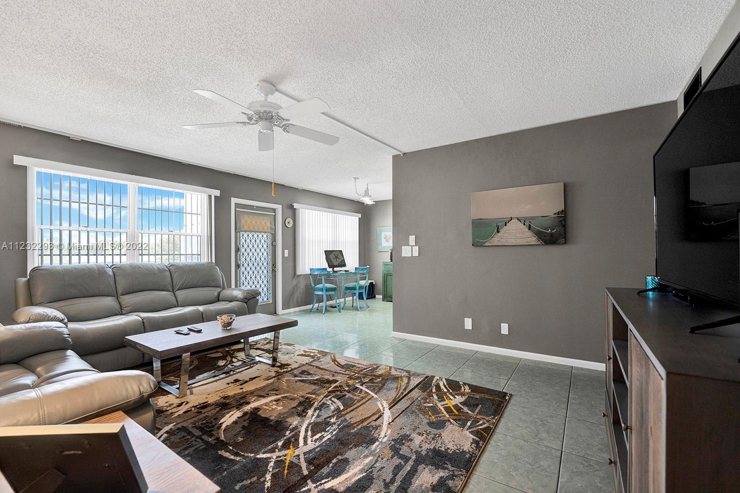 Cozy 2/2 is ready to make your own! Property features stainless steel appliances in the kitchen, ceramic tile floors, large enclosed patio overlooking the green and so much more. Make this your home today!