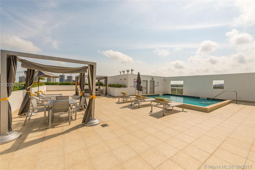 Beautiful corner townhome in Coconut Grove in gated community! Trilevel unit features many upgrades such as all wood floors and built in cabinets. 2 bedrooms and 2.5 bathrooms plus office/den. 2 balconies. Lots of storage space and a 2 car garage. Amenities of the building include gym and roof top pool with amazing Miami skyline views!  Lots of guest parking. Can be sold furnished.