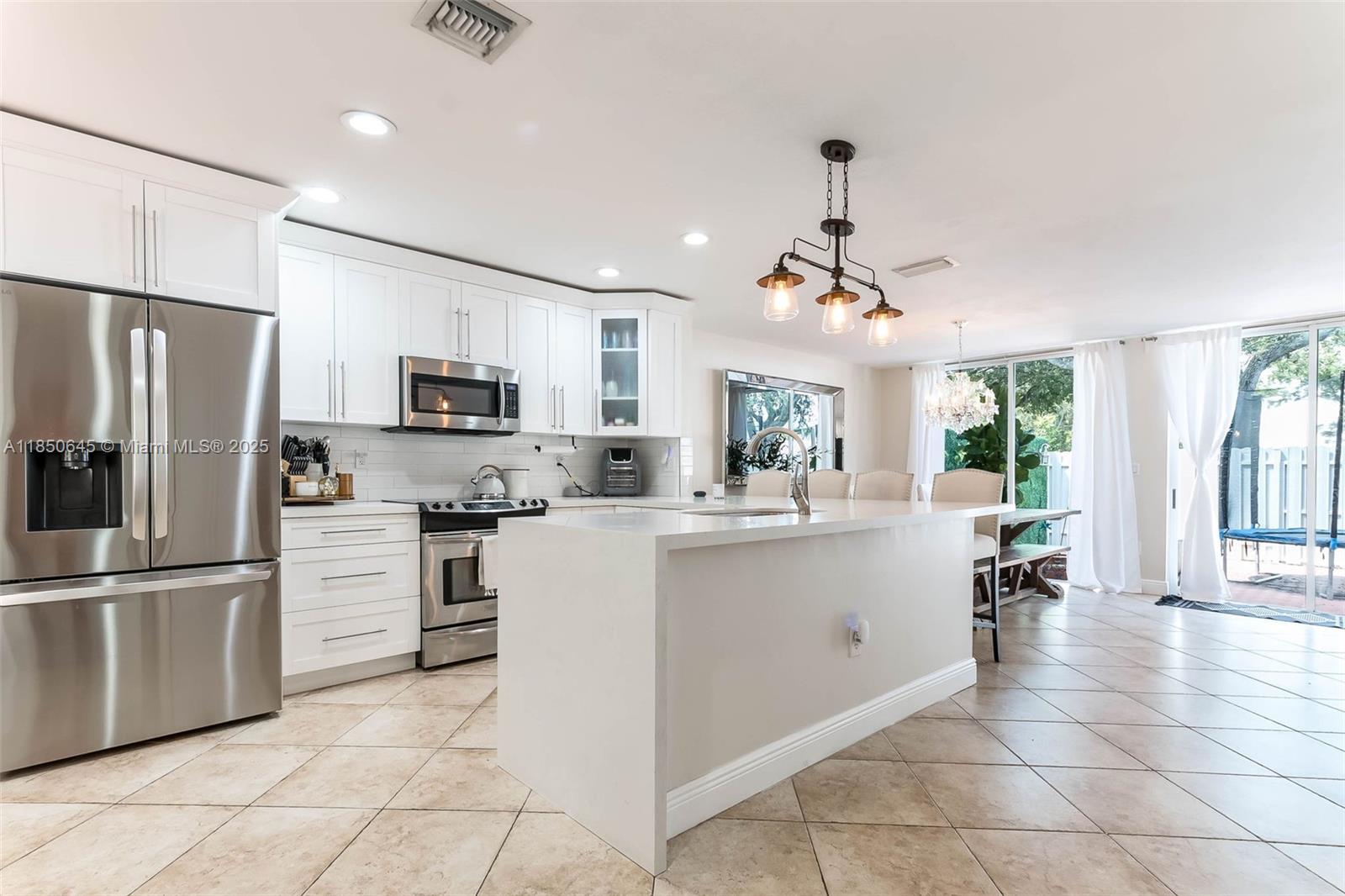 Welcome to your beautifully renovated 3 bed, 2.5 bath townhome (that feels like a house!) in the gated Doral Greens community. This elegant residence offers 1,898 square feet of light-filled living space. The home features a 2024 roof, an amazing kitchen with charming breakfast nook, while decorator-quality bathrooms, spacious bedrooms, and large custom closets enhance the luxurious feel. The spacious and serene private patio is perfect for outdoor relaxation. Residents enjoy exclusive access to the esteemed Doral Park Country Club, which offers tennis courts, a gym, dining options, and a resort-style pool. Features one-car garage, driveway, and plenty of visitor parking. Close to A+ schools and all the numerous dining establishments Doral has to offer.