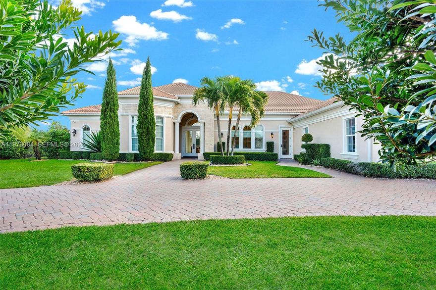 Located in the prestigious gated community of Sterling Ranch, this custom single-story estate offers refined design and effortless indoor-outdoor living with a direct view of the Hardrock Guitar Hotel. A grand circular paver driveway and manicured landscaping create striking curb appeal and plenty of parking. Inside, 12-foot soaring ceilings, polished stone floors, and expansive windows fill the home with natural light. The open-concept layout features a seamless flow into the chef’s kitchen oversized quartz islands, custom cabinetry, stainless steel appliances, double ovens, wine refrigeration. The primary suite overlooks the pool and features a spa-inspired bath with dual floating vanities, freestanding soaking tub, and oversized glass shower. Secondary bedrooms are generously sized while each additional bedroom includes its own ensuite bath for exceptional comfort and privacy. Step outside to a resort-style backyard with freeform pool, integrated spa, expansive travertine decking, and covered lanai. Lush hedging provides privacy while maintaining an open feel. Additional upgrades include a whole-home water filtration and softener system, central vacuum, tankless water heater, impact windows and doors, a circular paver driveway, and a three-car garage for extensive parking. Ideally located minutes from the Turnpike, I-95, I-75, Fort Lauderdale Airport, this home delivers luxury, convenience, and lifestyle in one package. HOA includes all landscaping, trimming and mowing.