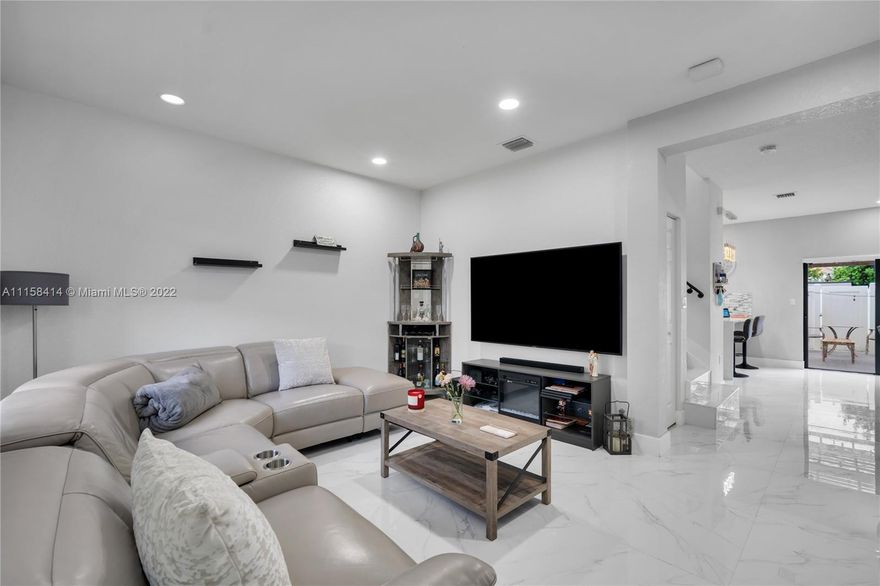 Stunning, completely renovated 3bed/2.5bath located in the beautiful community of Aquabella. This townhome has beautiful porcelain floors throughout the 1st floor and staircase which includes an updated metal railing - vinyl floors upstairs. A custom-built electric decorative fireplace with TV installed, updated kitchen, updated bathrooms, updated light fixtures throughout, and ceiling fans in bedrooms. Custom cabinetry in closets. Full Smart Home Alexa System included. Upstairs bathrooms come with large LED mirrors. The backyard patio includes a custom-built pergola with a section of artificial turf. Resort-style amenities include a deluxe clubhouse, fitness center, two large swimming pools, and a beautiful private lake.
