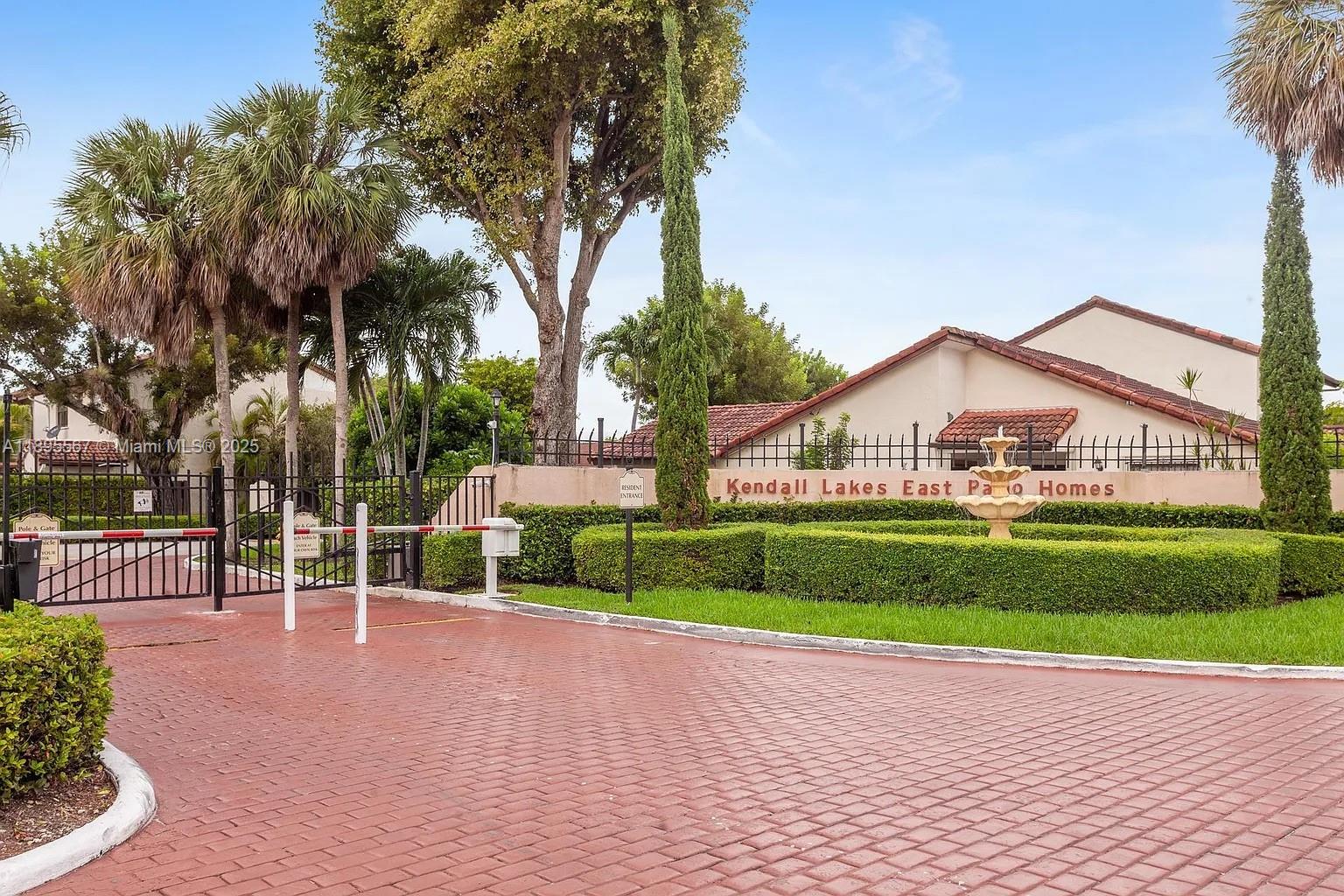This charming corner cluster home offers 2 spacious bedrooms and 2 full baths in a secure, gated community. Enjoy a welcoming front courtyard that leads to the main entrance, plus a convenient storage room and a beautifully remodeled kitchen. The home features vaulted ceilings, accordion shutters throughout, and a 2017 roof for peace of mind. Outside, you’ll find a fenced backyard with a cozy terrace—perfect for relaxing or entertaining. Includes 3 private parking spaces and ample guest parking. Community amenities include a clubhouse and a sparkling pool.