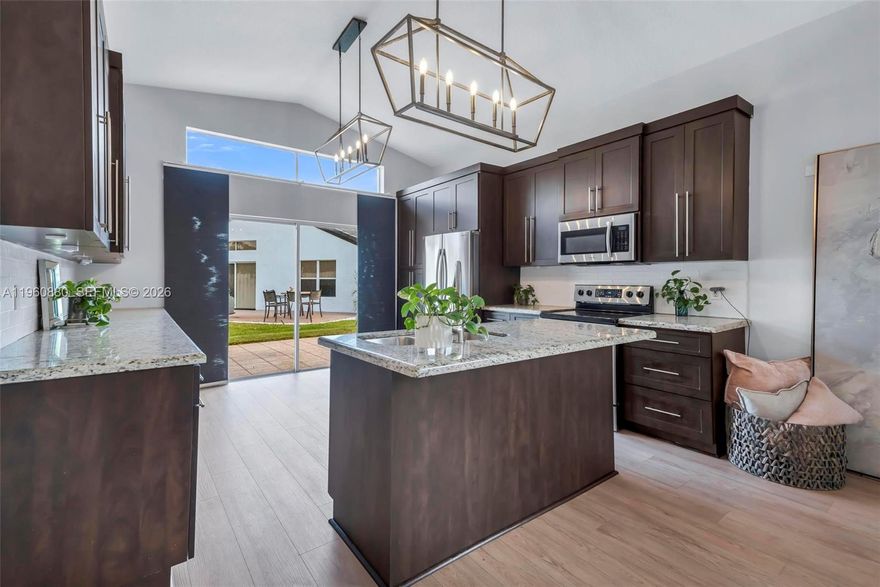 Beautiful 4-bedroom, 2-bathroom home featuring soaring vaulted ceilings and an abundance of natural light throughout. The bright, open layout seamlessly connects the spacious living room and newly updated kitchen, creating the perfect space for both everyday living and entertaining. The kitchen features stainless steel appliances, tons of cabinet space for storage, and ample counter space. Enjoy brand-new flooring throughout the home along with fresh interior paint and beautifully updated bathrooms that give the home a clean, modern feel. The generously sized bedrooms provide comfort and flexibility for family, guests, or a home office. Step outside to a nice patio area, perfect for relaxing or entertaining. Move-in ready and offering the perfect blend of space, updates, and functionality.