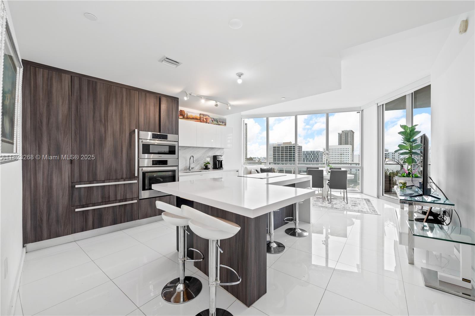 Experience unparalleled luxury in this impeccably designed 1 Bed + Den, 2 Bath condo located in the vibrant heart of Miami World center. With soaring 10-foot ceilings and a private elevator entrance, this home exudes sophistication and exclusivity. The European-style kitchen combines elegance and practicality with premium appliances, making it perfect for both everyday living and entertaining Indulge in an array of resort-style amenities: Indoor basketball and racquetball courts. Relaxation lounge and conservatory, State-of-the-art fitness center with boxing and aerobics zones, Spa/salon for ultimate pampering, Tennis courts, barbecue areas, and a children’s playground, Teen room and entertainment space.