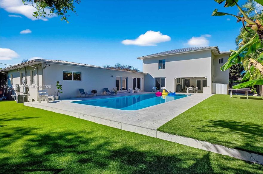 Modern, move-in ready private oasis on an oversized, private corner lot in the heart of Biscayne Park. This spacious 5-bedroom, 5-full-bath home is designed for real life with kids, entertaining, and work-from-home flexibility. The fully fenced backyard is all turf and offers exceptional privacy and space to play, while the large pool, covered patio, outdoor kitchen, and convenient full pool bath create a true indoor-outdoor lifestyle perfect for hosting BBQ’s, pool parties and more. The smart, flexible layout features four bedrooms on the first floor and a private primary retreat occupying the entire second level. The upstairs suite includes a spa-like bath with soaking tub, separate shower, private water closet and a generous walk-in closet, plus extra space ideal for a home office, gym, nursery, or expanded closet. Living areas include a formal living room, expansive family room overlooking the pool and green space and a huge eat-in kitchen with abundant storage and space for a large dining table—perfect for shared meals, homework time, and entertaining friends. Additional highlights include impact windows, upgraded plumbing and electrical, natural gas, full-house generator, indoor laundry room, oversized storage room off the kitchen, and a full workshop, which could be converted for live-in help. Ideally located near museums, parks, gyms and various private schools like Miami Country Day, St. Rose of Lima, Montessori and Cushman. Biscayne Park is the ultimate gem.