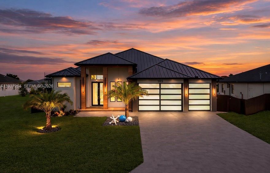 Experience the pinnacle of Southwest Florida living in this brand-new ultra-luxury residence located in one of Cape Coral’s fastest-growing areas. Perfectly positioned just minutes from the boat ramp and near the highly anticipated Seven Islands Project and The Grove at Cape Coral, this home places you at the center of the city’s future waterfront dining, entertainment, and boating lifestyle. Inside, over 2,400 square feet of thoughtfully designed living space unfolds beneath soaring ceilings and expansive 10' impact glass sliders that flood the home with natural light and create seamless indoor-outdoor living. Imported 48x48 porcelain tile flooring, designer lighting, and sleek architectural lines elevate the home’s modern coastal elegance. The chef’s kitchen is the centerpiece of the home, featuring stunning Taj Mahal countertops, custom cabinetry with integrated lighting, and premium appliances perfect for entertaining. The spacious primary suite offers a true retreat with a custom LED-lit walk-in closet, spa-inspired bathroom, and direct access to the pool area. Step outside to your private resort-style oasis featuring a spectacular 14x28 pool with integrated spa, floating steps, ambient LED lighting, outdoor kitchen, and tropical landscaping designed for relaxation and entertaining. Highlights include smart home features, a spacious 3-car garage, and a prime location near boating, dining, shopping, top-rated schools. This home delivers the ultimate Cape Coral lifestyle.