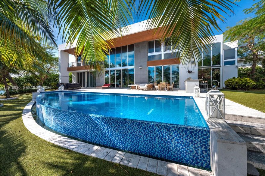 Exquisite Waterfront Residence With Private Dock boasts an impressive 270 feet of water frontage. Step into your own private paradise with this meticulously crafted single family house nestled in the heart of gated Golden Isles. Placed on a huge corner waterfront lot, this property offers spectacular water views, best location and new sea wall, direct ocean access, with no fixed bridges. This exquisite luxury residence with 6 Bed/ 6 Bath/ 1 Half Bath, Spacious Master Bedroom, Elevator, Private Gym, Sauna, Beautiful Infiniti Pool, Top of the line appliances, luxury finishes. The neighborhood has new tennis courses, double dog park, new recreational park. Schedule your private tour today and experience the beauty of this home firsthand