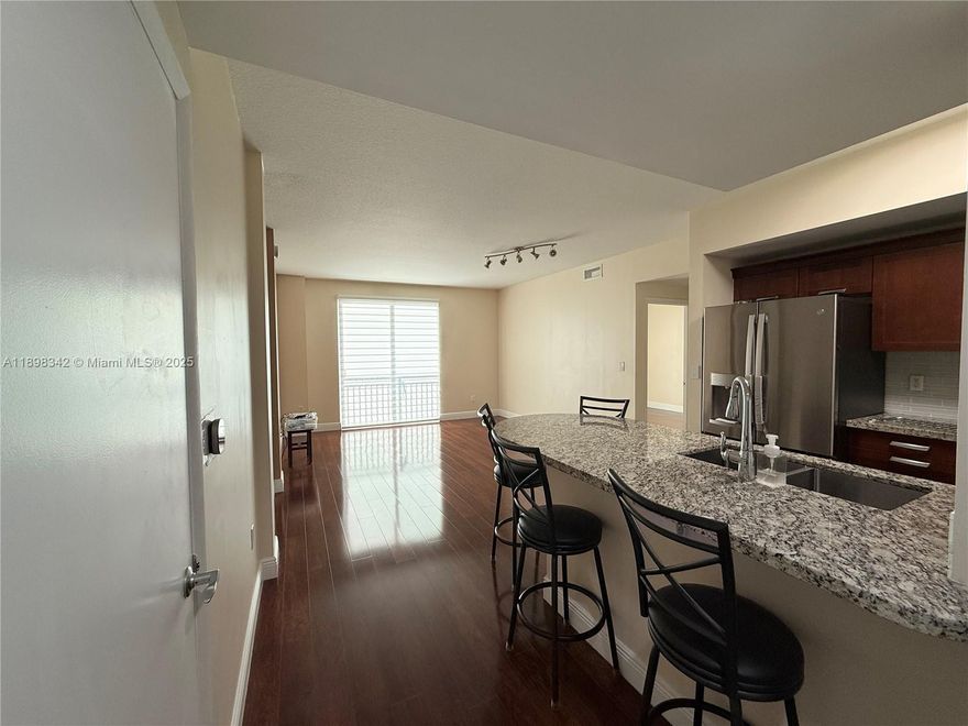 Beautiful 2 Bedroom 2 Bathroom split unit in the Amazing Downtown Dadeland, featuring 2 ASSIGNED PARKING SPACES. The unit offers wood flooring throughout the living areas and bedrooms, an open-concept kitchen with granite countertops, SS appliances, and sleek European cabinetry. The spacious primary suite includes a large custom ELFA walk-in closet. Washer & Dryer in unit. The Rooftop pool, Spa & State of the art Gym are located in the same building. Unbeatable location just steps from Publix, Trader Joe’s, Metrorail, and directly across from Dadeland Mall. Super close access to 826 & US1. THE RENT INCLUDES WATER, CABLE TV, INTERNET, GARBAGE, A/C FILTERS, AND ALL HOA AMENITIES. 24/7 security patrol. No pets allowed. **Renter's insurance required**