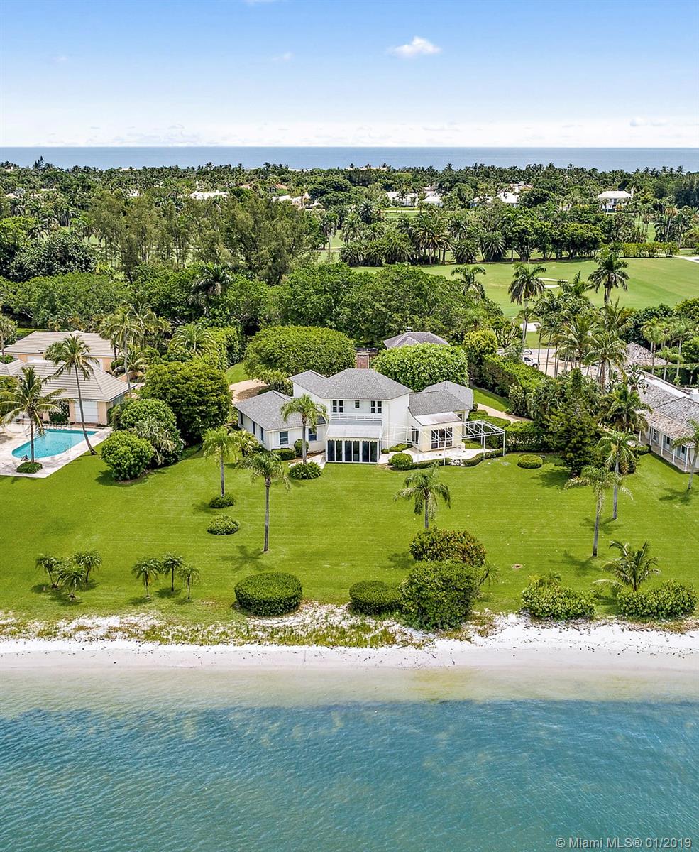 BEST VALUE ON THE INTRACOASTAL ON JUPITER ISLAND! Designed by renowned architect Kemp Caler to ensure that each room would have spectacular Intracoastal views, this wonderful Jupiter Island house and guest house sit on 1.2 acres with panoramic vistas across to nature preserve. The main house with 195' of frontage features 4 guest bedrooms plus a maid's room. There are multiple, expansive entertaining spaces for family or guests including a living room, dining room and loggia. Outside, a large terrace is the perfect spot for watching Intracoastal boat activity and Jupiter Island's spectacular sunsets. The guest cottage has a living room, bedroom and bath plus an efficiency kitchen.