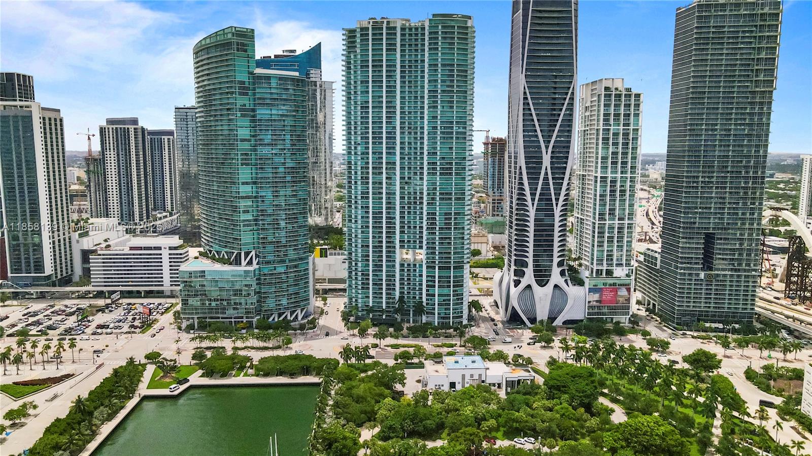 Experience breathtaking bay and city views from this exceptional residence in one of Biscayne Boulevard’s most iconic and uniquely designed buildings. This spacious 2-bedroom+enclosed den with closet offers 3 full baths and an expansive layout with soaring 10-foot floor-to-ceiling windows that flood the space with natural light. Enjoy seamless indoor-outdoor living with 2 oversized terraces offering both East and West exposures. The Italian-designed kitchen is equipped with premium Sub-Zero and Miele appliances. Indulge in resort-style amenities including temperature-controlled pools, a full-service spa with jacuzzi, sauna, steam room, locker rooms, a state-of-the-art fitness center, and an in-house movie theater. In the heart of Miami’s cultural and entertainment corridor.