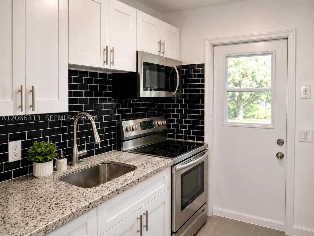 Photo of 309 Phippen Waiters Rd #2, Dania Beach, FL 33004 (MLS # A12066313)