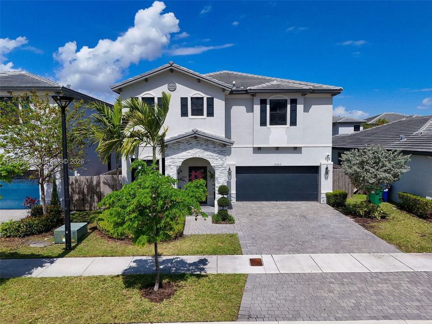 This exceptional 5-bedroom, 3.5-bath home in the desirable Pine Vista community opens to a bright & spacious living & dining area. A welcoming family room overlooks the kitchen, features stainless steel appliances, ample cabinetry, & a generously sized pantry. The property includes three separate entryways & hurricane-impact doors, providing added flexibility, security, & peace of mind. The impressive primary suite is expansive & versatile, offering ample room for a sitting area, home office, or additional furnishings. It also features an oversized closet with custom built-ins. The primary bathroom is well-appointed with a jacuzzi tub, separate shower, and dual vanities. The additional bedrooms are well-proportioned and comfortably sized, providing flexibility for family, guests, or multi-use spaces. A full bathroom on the first floor offers direct access to the outdoor area—ideal for poolside use.Step outside to a private backyard with a sparkling heated pool, inviting lounging area, & an expansive patio with plenty of space to relax and entertain. The two-car garage has been upgraded into a gym featuring top-of-the-line new equipment, while still offering ample storage space.
Additional features include a dedicated laundry room & thoughtfully designed living areas throughout. Residents enjoy resort-style amenities including a modern clubhouse, fitness center, & community pool.
Don’t miss this opportunity to own a beautifully designed home in a sought-after community!