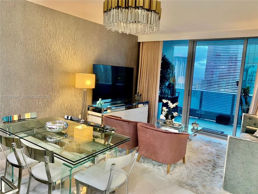 Luxurious unit! Featuring Versace wallpaper, 3D walls, blackout shades, and motorized fabric curtains. This top-floor one-bedroom, one-and-a-half-bath residence is priced competitively. It boasts premium Snaidero cabinets, Sub Zero and Miele appliances, Italian marble bathrooms, and custom Italdoors with magnetic locks. Enjoy stunning city and partial river views from the balcony. Amenities include a sunrise resort pool and a private sunset residence pool. Residents have access to cabanas, a spa, a fitness center, and both casual and fine dining on-site. Additional features include 24-hour valet, concierge, and security services. Located just 2 blocks from Whole Foods, within walking distance to Brickell City Centre, only 5 miles from South Beach, and 7.5 miles from Miami International Airport.