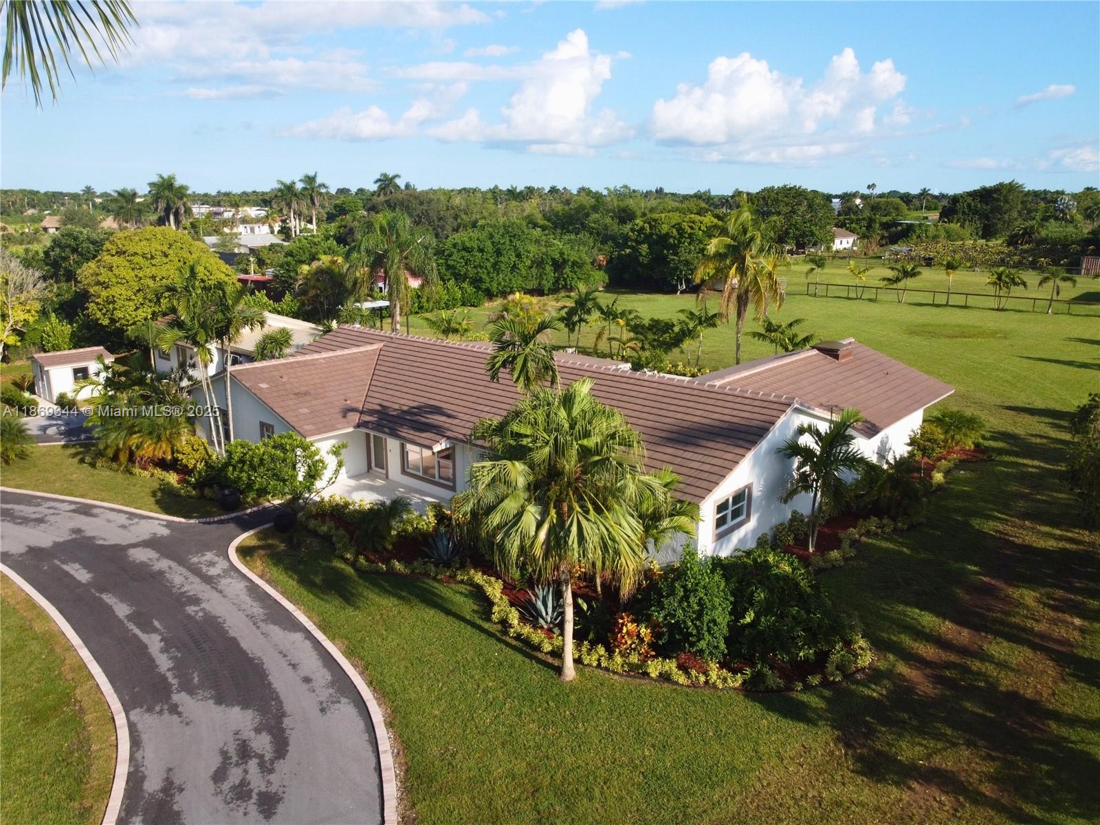 Fully Renovated Redland Equestrian Estate 2.2+ acre modern living with horse stables and pool. The Master Bedroom features dual walk-in closets and a spa-inspired bathroom with a 40 jet Jacuzzi tub and sauna. Three additional bedrooms are fully furnished, plus a separate large room, close to the family room is design and set up as a game room. The estate recently underwent a $1M+ complete renovation, updating every detail—new tile roof, impact windows and doors throughout, new AC units, all new kitchen cabinets and appliances, new bathrooms vanities and fixtures, 4’ x 4’ porcelain tile flooring throughout. In addition to the main home, there is a separate 1 bedroom 1 bath with full kitchen and living room for either in-laws’ quarters or guest house.