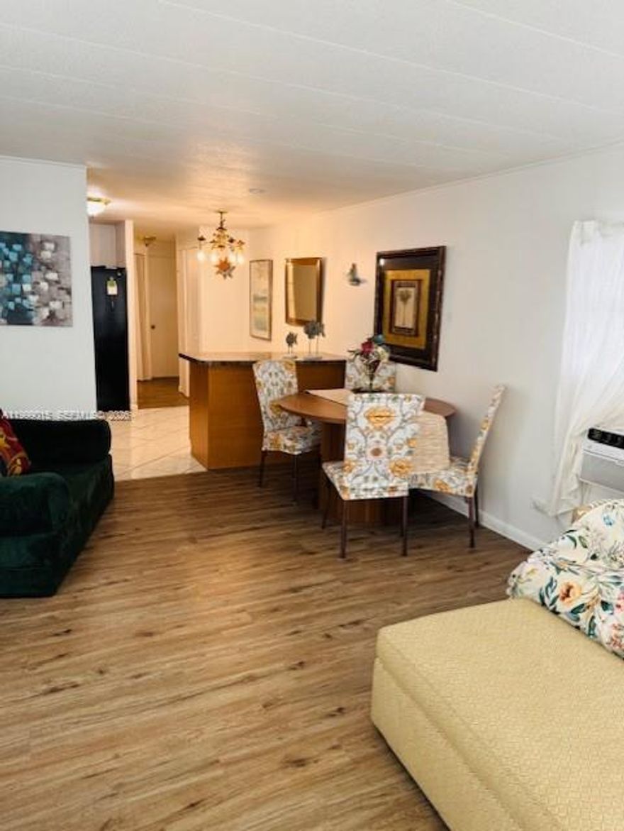 Stunning fully renovated 2-bedroom, 2-bathroom home featuring a unique layout with 2 kitchens, ideal for extended family or income potential. Bright living and dining areas plus a charming Florida room. Enjoy a private patio with beautiful lake views. Private parking included. Located in a secure, well-maintained community with security service. Move-in ready and perfect for homeowners or investors. Rare opportunity!