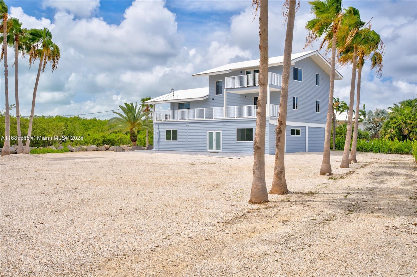 INVESTORS and BUILDERS must see this Buccaneer Point Estates bay access home with an L-shaped pier dock plus boat lift on almost 1/2 acre of land! Great value here with land alone plus you can customize this home to suit your needs and update with a new pool, summer kitchen and bar area. Own in this prestigious neighborhood of multi million dollar homes for a fraction of the cost. The features of the main living level include an interior staircase for main entry plus a stainless steel island kitchen, hard wood cabinets, tile throughout, tongue and groove pine ceilings and expansive porches off the great room. On the same floor, the guest wing has a laundry room, 2 guest bedrooms with walk in closets and a shared bath plus wide open lake views.