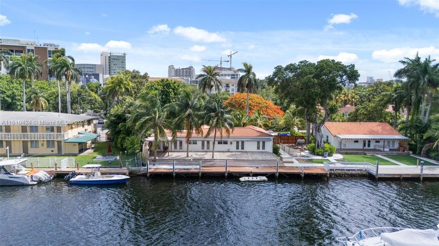 Deep, 96-foot River FRONTAGE! 2,195 sf water-front home. Totally renovated 2 years ago. Includes 4 beds / 3 baths. Lot size: 13,915 sf. Situated along the Miami River in the Spring Garden district (next to a neighborhood mini park). Interior features: high wood-beam ceilings, stone flooring, kitchen with center kitchen island, a dining area, living room, w/d, d/w, French doors that lead to the wooden deck & views of the 100-foot private dock. Driveway for 2/3 cars. Owner motivated! Vacant and ready to move in! Do Not Miss out on this unique opportunity! Boater's DREAM DOCK on the Miami River!