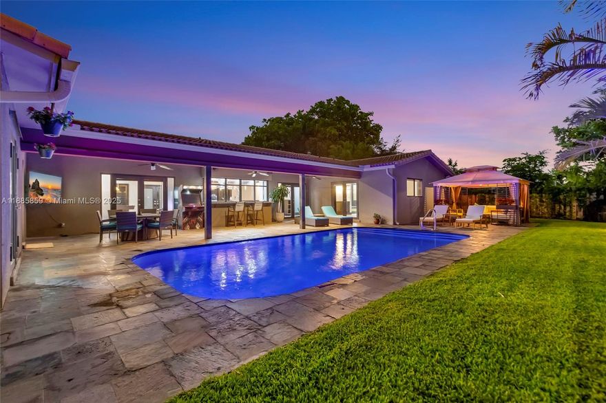 Step into elevated coastal living in Coral Ridge Country Club Estates with this 3-bedroom plus enclosed den (currently styled as a guest suite), 3-bath residence and air-conditioned 2-car garage. An open layout flows into a chef’s kitchen with double ovens, granite counters, wine cooler, and a cooking island with a pass-through bar to the covered veranda, designed for seamless indoor outdoor entertaining. Two private primary suites offer custom walk-in closets and French doors opening to the pool. Nearly every room overlooks the outdoor oasis featuring a cabana, hammock lounge, and spacious fenced yard. Located one block from the golf course and minutes to the beach, premier dining, and top private schools. Arrive by golf cart and live the Fort Lauderdale lifestyle.