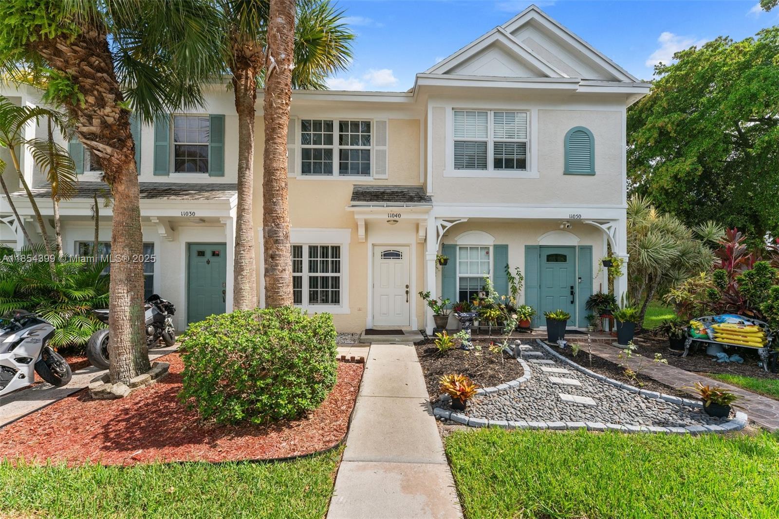 Experience the best of West Tamarac living in this delightful 2-bedroom, 2.5-bathroom townhouse. Located in a tranquil community. You'll be just moments away from major highways, shopping centers, and top-rated schools. This home is designed for modern living, boasting brand new impact windows and doors. The updated kitchen features stylish cabinets, stainless steel appliances, and a gas connection for both the stove and water heater. The elegant tile flooring on both levels adds a touch of sophistication. Privacy is key with two spacious upstairs bedrooms, each with its own en-suite bathroom. Relax or entertain on the covered back patio, which offers extra storage and serene views of a lush green area. Make this your new home today!