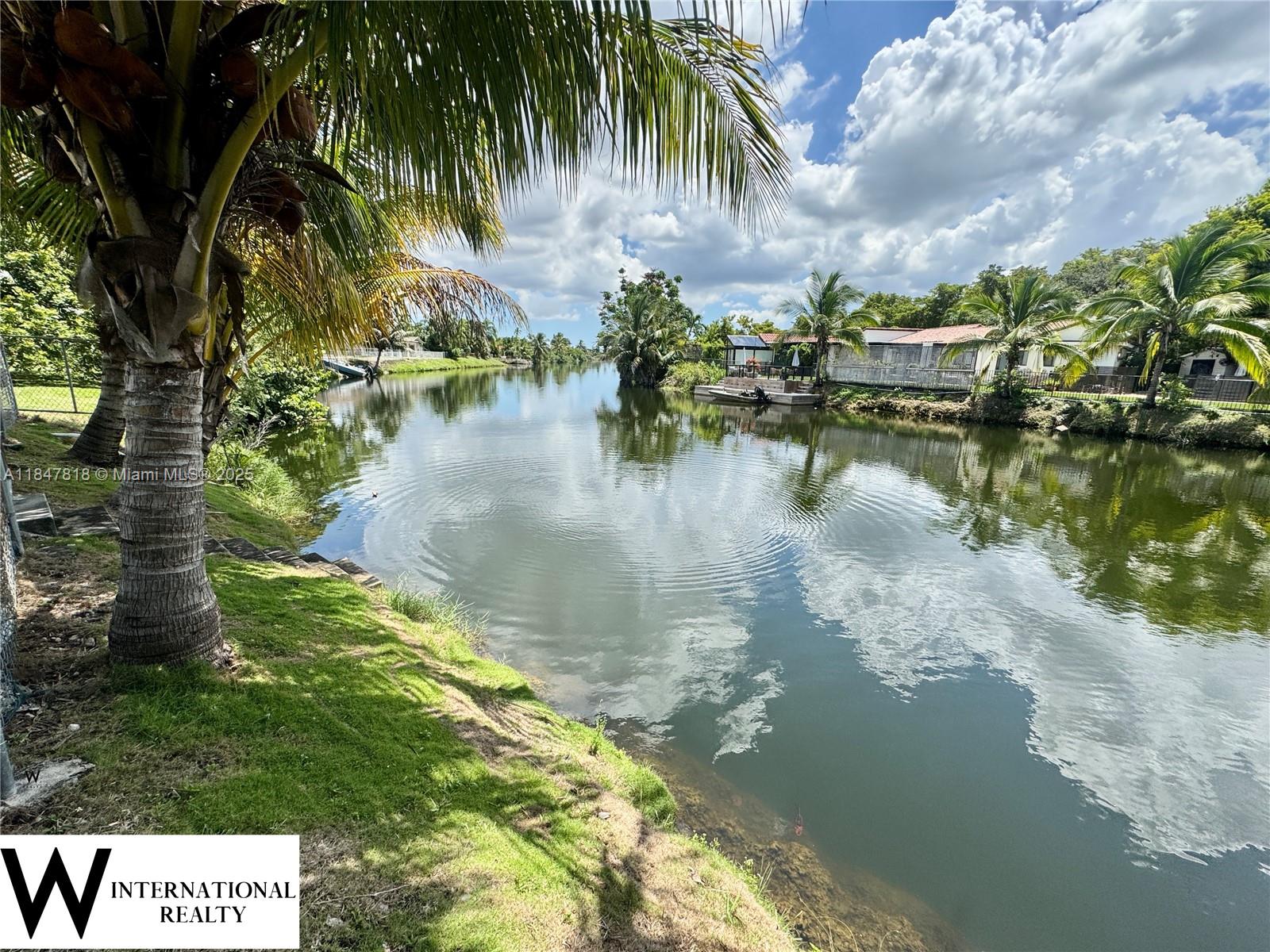 Spacious canal-front home on an oversized lot with pool, ideally located in a desirable Miami neighborhood. Tucked away at the end of a quiet cul-de-sac, with a huge circular driveway, offers privacy and ample parking.
Multiple living areas, a formal dining room, a family room, and a spacious kitchen with granite counters. The screened-in patio with wood-beam ceilings overlooks a sparkling pool with a waterslide, while the fenced backyard opens to a wide canal with steps to the water. Inside, the home is ready for updating, allowing buyers to customize and add value. With its spacious layout, canal frontage, and outdoor amenities, this property is a rare opportunity to create your dream retreat. Located close to top-rated schools, highways, shopping, and dining.