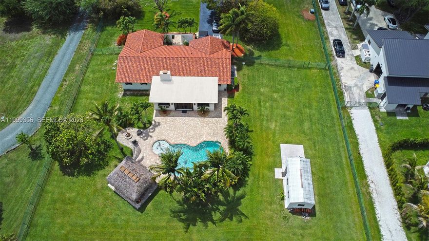 This stunning ranch-style estate located on over an acre lot in the highly sought-after equestrian community of Southwest Ranches. This property offers a rare combination of privacy, freedom, and spacious living.
The home features three bedrooms and three full bathrooms, plus a versatile flex room ideal for a gym, office, or guest quarters. Interior highlights include porcelain tiles throughout the common areas and custom wood kitchen cabinets equipped with a double wall oven, gas stove, granite countertops, stainless steel appliances, and a generous island. The trending open concept of the home features a double-sided fireplace connecting to the living room. 
The outdoor  features a resort-style saltwater pool with a Baja shelf, a large paver deck, and tropical landscaping. Additional amenities include a tiki hut with a built-in kitchen, bbq, a fire pit, and a sprawling fenced backyard perfect for large gatherings. Also included is a 12 x 24, (288) sf shed on a concrete slab, perfect for storage or a workshop. Plenty of room for your motorhome, RV, boat and toys. Horses ok.
Hurricane accordian shutters and window panels for protection.