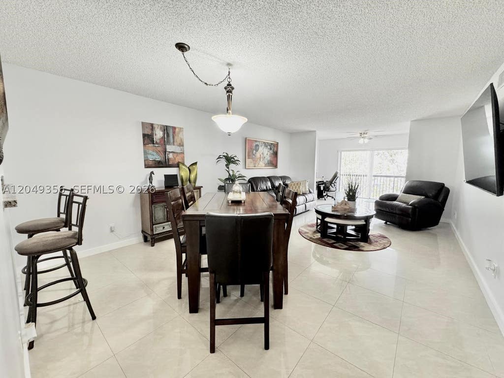 Photo of 4975 E Sabal Palm Blvd #311, Tamarac, FL 33319 (MLS # A12049356)