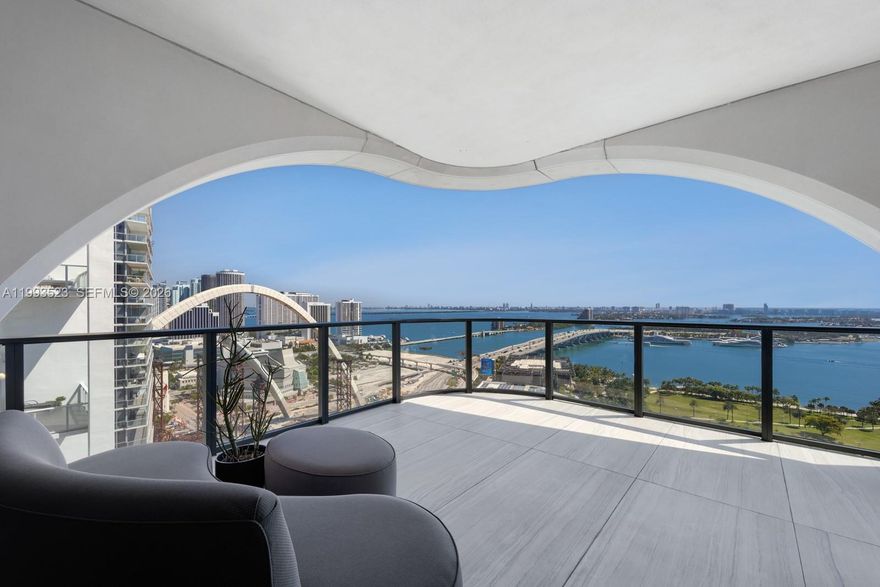 Rising above Miami's most iconic skyline, Unit 2702 at One Thousand Museum stands as a rare offering within Zaha Hadid's final architectural legacy, a 4-bedroom, 5.5-bathroom residence spanning 4,600 square feet of flawlessly curated living space. Positioned in one of the most privileged lines in the building, Unit 2702 commands breathtaking Northeast-facing direct ocean and Biscayne Bay views and Miami's most stunning sunrises.
Completely reimagined from scratch by renowned architect Luciana Junqueira, every inch reflects an uncompromising commitment to luxury. Suspended plaster ceilings integrate custom lighting, a whole-home sound system, motorized shades, and concealed AC — all inspired and engineered to honor Zaha Hadid's iconic architectural language, designed and installed by AHT Global.
Wallpaper Miami adorns every room, water-resistant textures in living areas, silk-infused in the powder room, and straw-woven in the master suite. Custom Madeira Bambu millwork by Oliver flows throughout, representing nearly $800,000 in customization. The living room features Roche Bobois' Bubble chair and custom Artefacto pieces atop wool and silk rugs. Two Roche Bobois statement tables and Gaggenau and Sub-Zero appliances complete the kitchen.
A true trophy residence in the sky. Offered fully furnished. Living in 1000 Museum is not simply an address. It is a legacy.