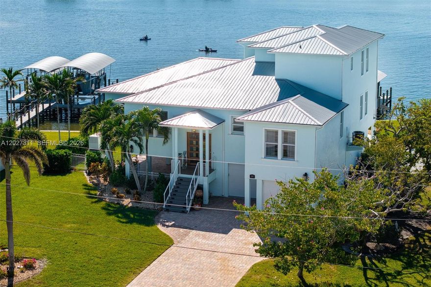 LUXURY LIVING AT ITS BEST IN ST. JAMES CITY! Perfectly positioned on the open waters of San Carlos Bay, this fully renovated waterfront estate offers deep-water Gulf access, unobstructed views, and island charm. Located at the southern tip of Pine Island, the home feels private and serene while remaining close to Cape Coral and Fort Myers. Rare wide bay frontage delivers breathtaking sunsets and endless open-water views, while over $400,000 in renovations provide exceptional quality and peace of mind, including a roof, spray-foam insulation, hurricane-impact windows and doors, whole-home generator, updated HVAC, ductwork, and instant hot water heaters. Boating enthusiasts will appreciate the protected deep-water dock with no bridges and two new boat lifts (6,000 lb. and 15,000 lb.) for effortless Gulf access. Outdoor living shines with a heated pool and spa overlooking the bay, a custom tiki hut, and a fully equipped outdoor kitchen. Inside, refined coastal finishes include wide-plank tile flooring, custom closets, and a chef’s kitchen featuring JennAir appliances, exotic granite countertops, and over $250,000 in custom cabinetry. Offered tastefully furnished in Tommy Bahama style (with exclusions), this turnkey estate also features an oversized four-car garage with epoxy flooring for up to six vehicles plus extra storage. A rare combination of luxury craftsmanship, energy efficiency, security, and true waterfront living in one of Southwest Florida’s most desirable locations.