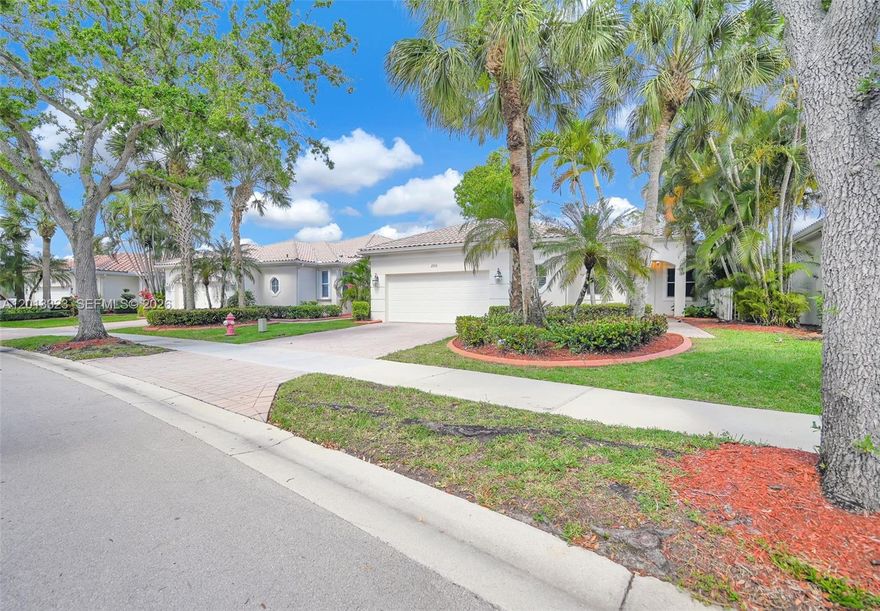 Stunning one-story waterfront residence in the gated enclave of Bay Pointe at Weston Hills. This 3BR/3BA home offers an open, light-filled layout with soaring ceilings and tranquil lake views. The kitchen features wood cabinetry, granite countertops, stainless steel appliances, and a breakfast nook. Main living areas showcase wood and tile flooring. The primary suite includes dual walk-in closets and a spa-like bath with soaking tub, shower, and dual vanities. One secondary bedroom is en-suite, ideal for guests. Enjoy breathtaking sunsets from the oversized screened patio overlooking a spacious, fenced backyard with room for a pool. Additional features include a large laundry room with sink and a 2-car garage. Resort-style amenities, top-rated schools, and prime access to I-75, dining, and parks.