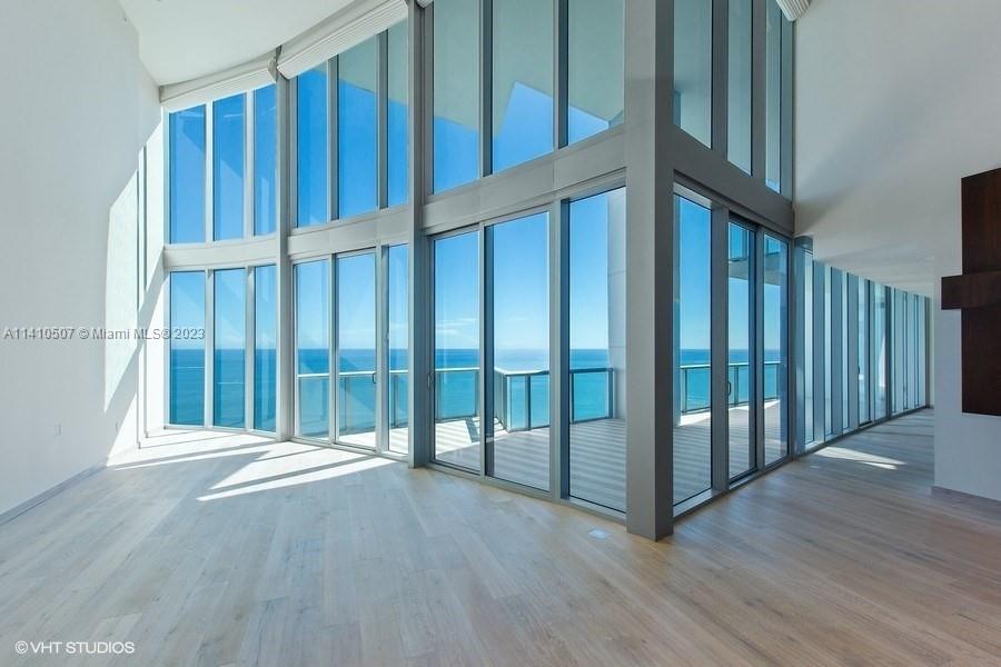 Private elevator leads you to a unique high-end completely remodeled two level Beach front 4BR + maid's quarters/ 5.5BA (4,141SF) penthouse with soaring 22' ceilings. Floor-to-ceiling impact windows throughout open to breathtaking unobstructed 180 degrees of flow through Ocean, City and intracoastal views. All en-suite, large bedrooms & living areas open to 4 amazing terraces. This PH incorporates the highest available in technology allowing full automation of temperature, lighting, blinds and music from your iPad. Downsview Italian kitchen featuring Calacatta marble countertops equipped with Miele appliances and wine cooler. Exquisite wallpaper & real wood floors through out and custom wood paneling in selected areas. Truly a must see! Enjoy all of the exclusive amenities.