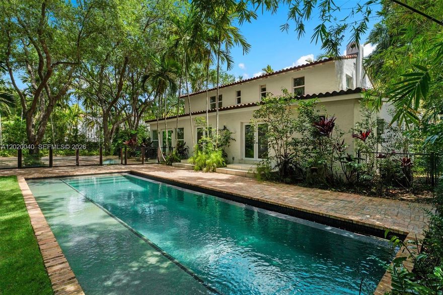 Newly renovated 1920s compound in Miami Beach’s prestigious La Gorce Country Club enclave, once owned by Carl Fisher. Set behind lush, mature landscaping, this private tropical sanctuary is framed by towering trees and layered greenery. The estate offers 3 residences totaling 7Bedroom/7BA, ideal for hosting or multigenerational living. The main residence features 4 en-suite bedrooms, complemented by 2 private guest homes—each with a kitchen, including a poolside residence (1BD/2BA/Den) and a second above the garage (2BD/1BA). Interiors showcase handcrafted wood cabinetry, quartz counters, Cuban tile, and wide oak floors. A 38-ft heated infinity pool anchors the grounds, with a Chicago brick driveway for 8 cars and a 2-car garage, delivering a tranquil, secluded ambiance with generous functional space.