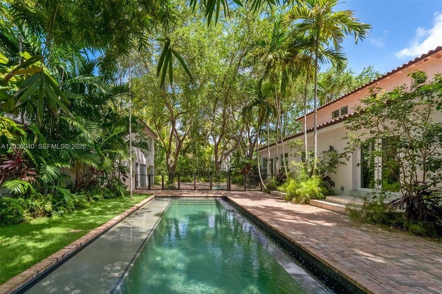 Newly renovated 1920s compound in Miami Beach’s prestigious La Gorce Country Club enclave, once owned by Carl Fisher. Set behind lush, mature landscaping, this private tropical sanctuary is framed by towering trees and layered greenery. The estate offers 3 residences totaling 7Bedroom/7BA, ideal for hosting or multigenerational living. The main residence features 4 en-suite bedrooms, complemented by 2 private guest homes—each with a kitchen, including a poolside residence (1BD/2BA/Den) and a second above the garage (2BD/1BA). Interiors showcase handcrafted wood cabinetry, quartz counters, Cuban tile, and wide oak floors. A 38-ft heated infinity pool anchors the grounds, with a Chicago brick driveway for 8 cars and a 2-car garage, delivering a tranquil, secluded ambiance with generous functional space.