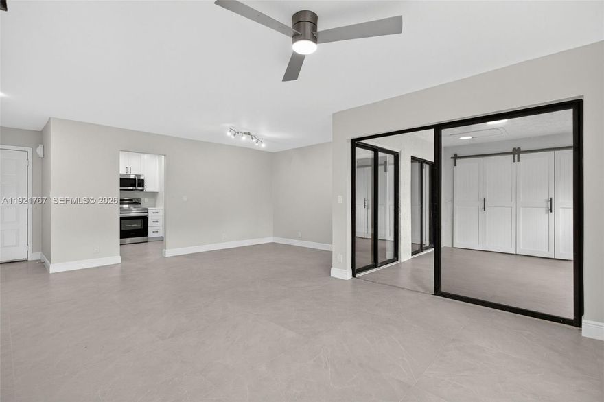 FULLY RENOVATED - ONLY 3% DOWN - MOVE-IN READY! Beautifully updated 3-bed/2-bath condo with porcelain tile throughout for a clean, modern, threshold-free look. 
Brand-new kitchen features white shaker cabinetry, quartz countertops, subway-tile backsplash, modern black hardware, and stainless Samsung appliances. 
Spacious open living/dining area with contemporary lighting and black-framed sliders that open to an extended screened balcony/lanai—matching tile, private treetop/water views, and a unique barn-door laundry closet with Samsung front-load set + utility sink. 
New primary bathroom with quartz vanity, designer mirror/lighting, and a spa-style tiled shower with matte-black fixtures. 
Located in The Township, Karanda 3, No Lease Restrictions, Coconut Creek with resort amenities including pool, fitness center, sauna, theater, basketball, and more. Pet/Cat-friendly community.


.: Rare 3BR/2BA in the community
.: 36x36 porcelain tile throughout (seamless/threshold-free)
.: New kitchen: quartz + all-new cabinets + stainless Samsung package
.: Extended screened lanai w/ matching tile + private water/green views
.: Barn-door laundry closet w/ Samsung W/D + utility sink
.: Brand-new primary bath: quartz vanity + large-format tile shower + matte-black fixtures
.: Updated lighting, fans, switches/outlets, doors & hardware throughout