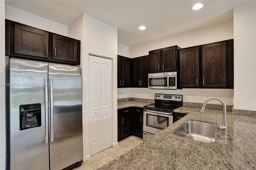 The Perfect First Home with newer construction & convenient to shopping, highway access. Want to avoid the "fixer-upper" headache? This 2018-built Deerfield Beach townhome offers nearly 1,600 sq. ft. of contemporary-modern living. Enjoy tile floors, stainless steel appliances, and high ceilings that make the space feel massive. Entertainer's dream, the kitchen flows seamlessly into the family and dining areas, keeping you part of the conversation while you cook. Smart storage includes a 1-car garage and extra storage space—rare to find. Less than 2 miles from the beach, giving you easy access to the best of South Florida coastal living. Meets newer Florida Building Codes—a huge plus for first-time buyers concerned about insurance costs. Low Maintenance and the association handling exterior maintenance are major selling points for someone moving from an apartment. Major Price improvement. First-time buyers should check with their Lender, as this property may qualify for Florida Housing Association Financing programs. Join a small, friendly, boutique-style community and start building equity today in one of Deerfield Beach's best-maintained residences. Motivated sellers.